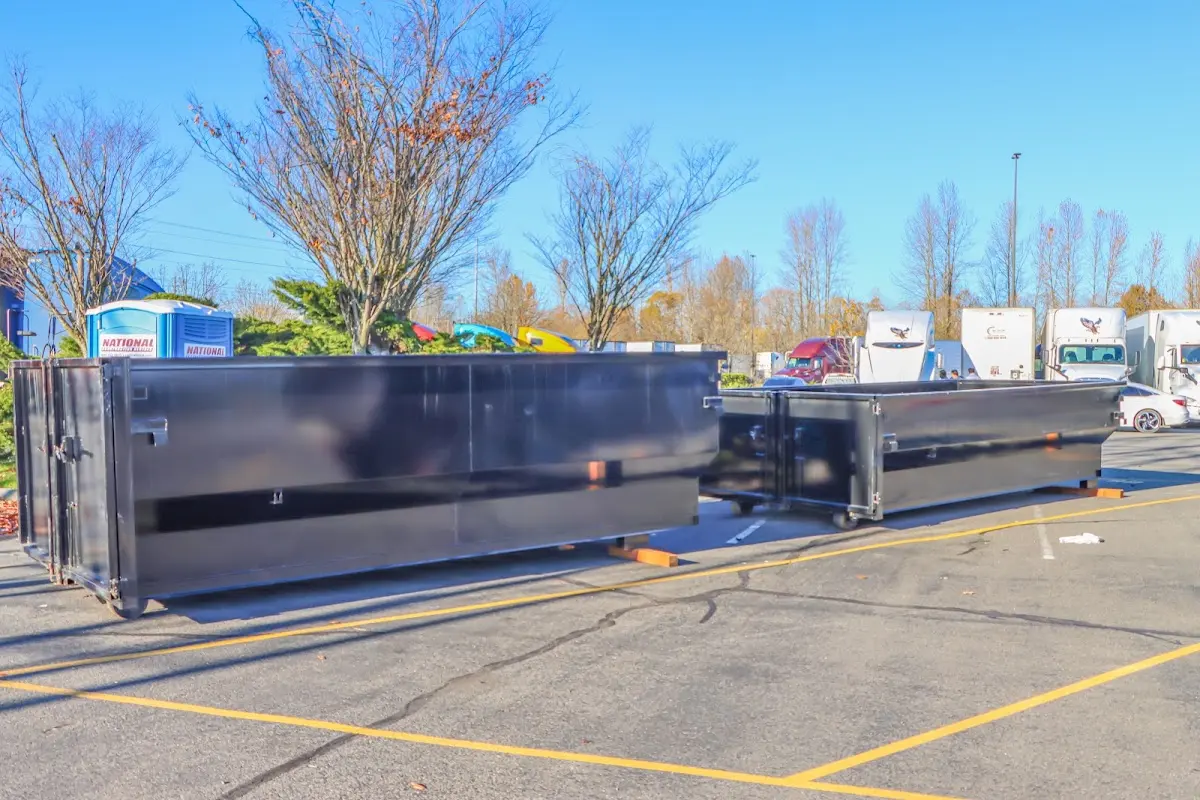 Professional dumpster rental service with roll-off container on residential driveway in Belle Fourche
